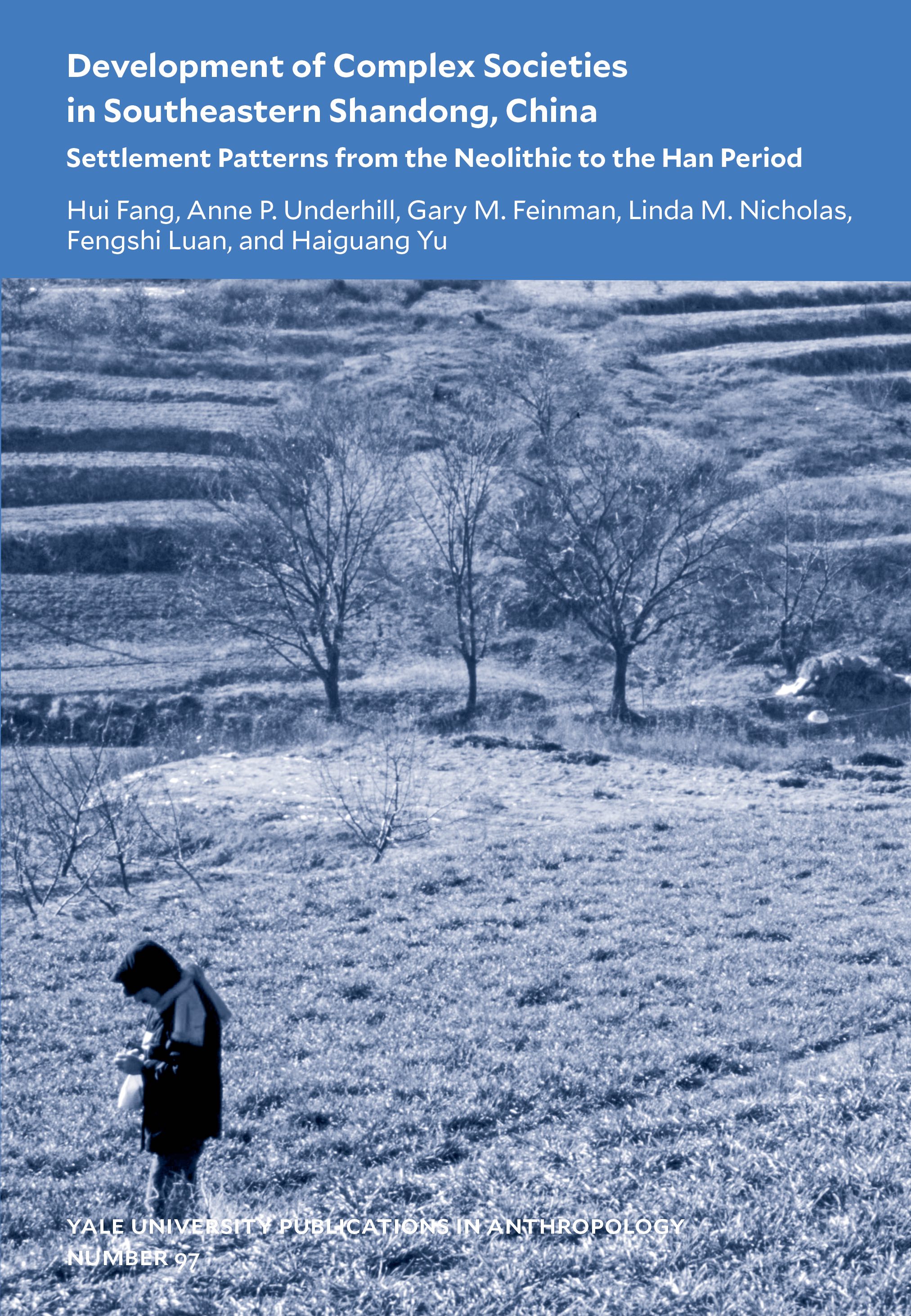 Blue-toned book cover with title above a photograph of man in a grassy landscape with terraced fields and small trees in the background